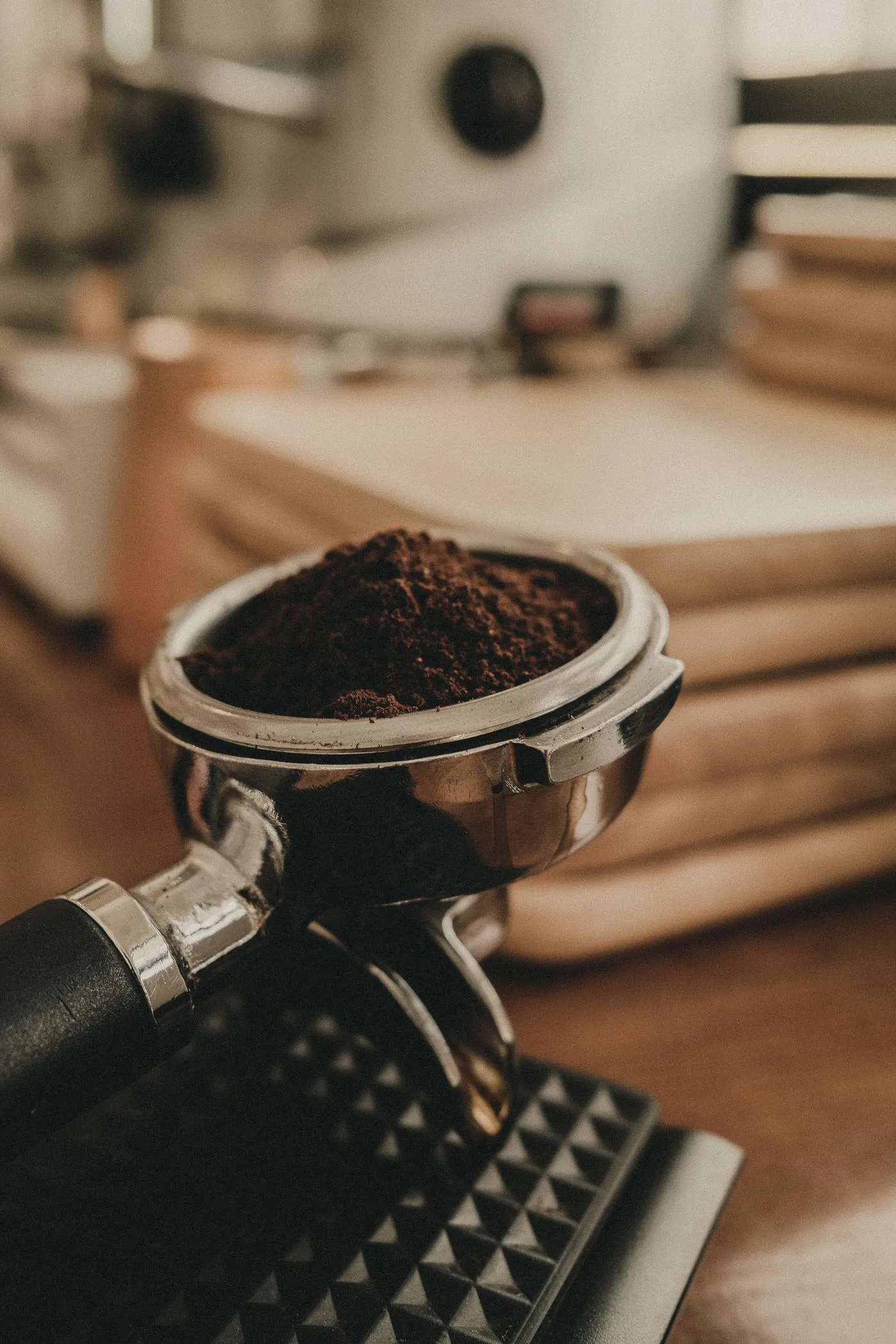 Discover Our Story Freshly ground espresso in a portafilter ready for extraction